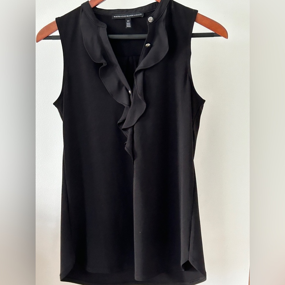 Black, sleeveless blouse from White House black market. Ruffled front.